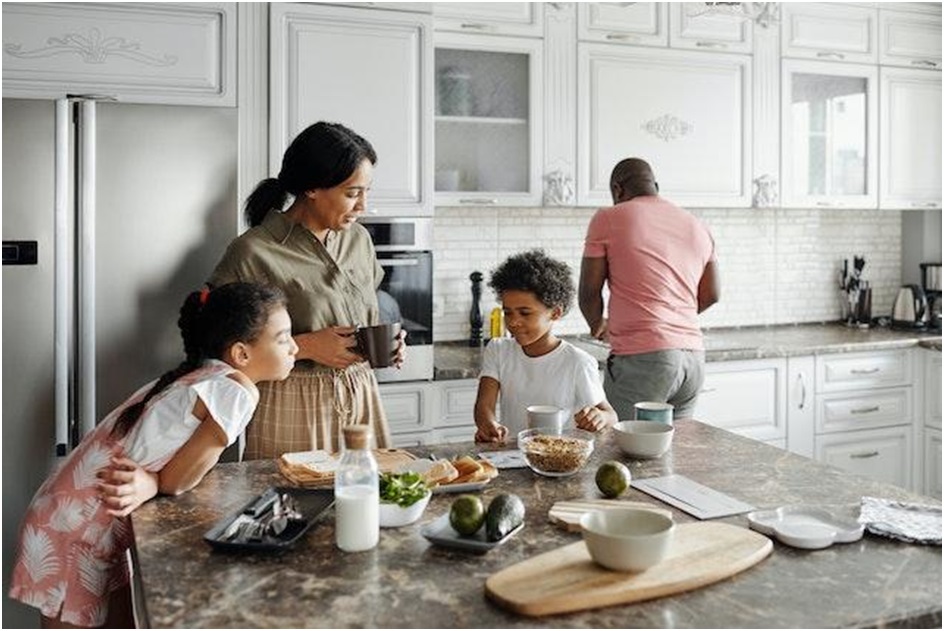 family cooking in kitchen of rental property